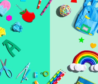 School supplies with a rainbow - overhead view - flat lay