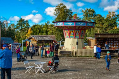 OSTERSUND, SWEDEN, SEPTEMBER 11, 2016: Old style swing on Jamtli museeum in Jamtland, Sweden clipart