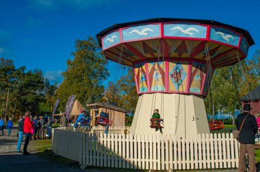 OSTERSUND, SWEDEN, SEPTEMBER 11, 2016: Old style swing on Jamtli museeum in Jamtland, Sweden clipart