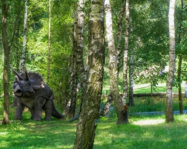 Triceratops dinosaur statue in entertainment park in Sweden clipart