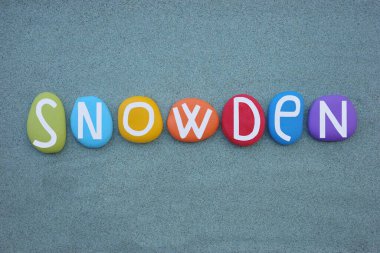 Snowden, masculine given name composed with multi colored stone letters over green sand