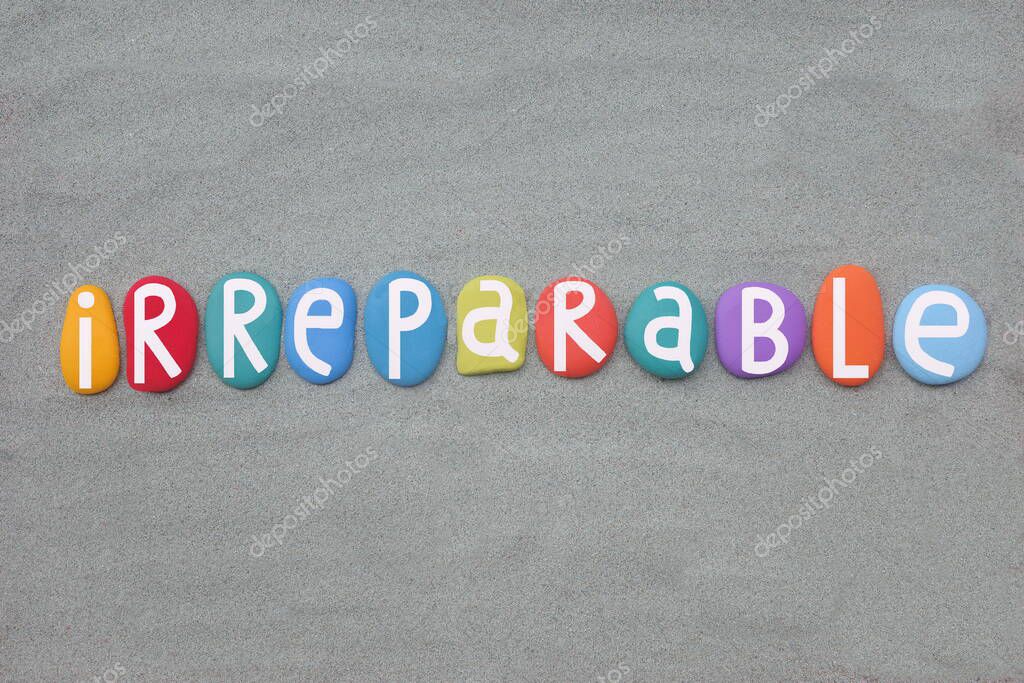 Irreparable, creative word meaning impossible to rectify or repair, composed with hand painted stone letters over green sand