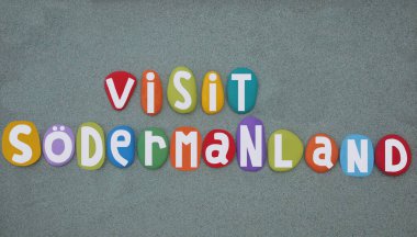 Visit Sodermanland, historical province on the south eastern coast of Sweden, creative touristic logo composed with hand painted multi colored stone letters over green sand clipart