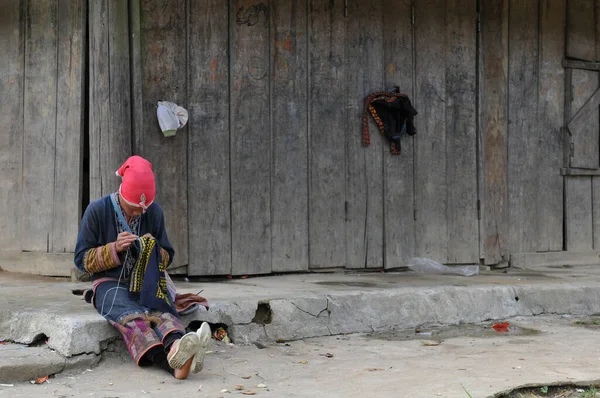 2010年8月11日 越南萨帕 村外木屋身穿传统服装和红帽针织服装的妇女 — 图库照片