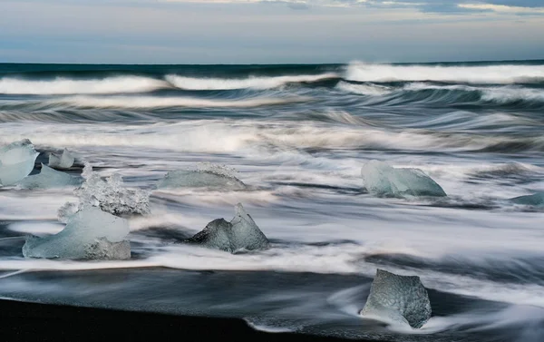 stock image Icebergs from Vatnajokull glacier, drop into Jokulsarlon lake and then to the Ice beach in Iceland. Global warming