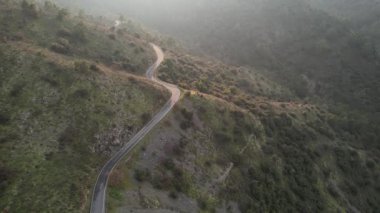 Windy empty mountain curved road at sunset. Drone footage. Troodos mountains