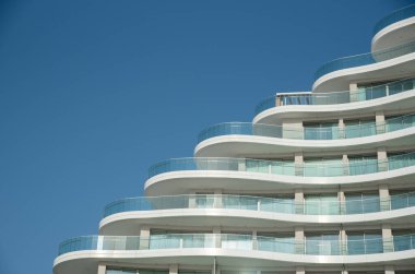 Modern office and home apartment building details against blue sky. Luxury real estate. Contemporary architecture design