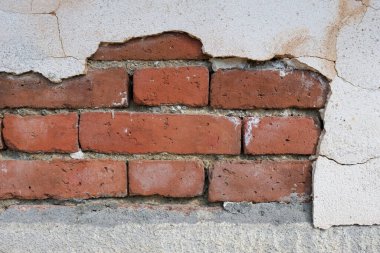 Architectural background white cracked wall brown bricks