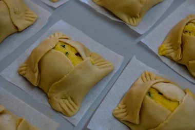 Traditional cypriot easter delicious cheese pastries ready to be cooked on a clay oven. Flaounes pies and are made with various cheese.
