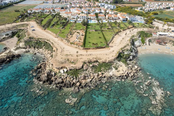 stock image Drone aerial of holiday village with luxury houses at an idyllic rocky coast. Summer vacations at the sea. Protaras Cyprus