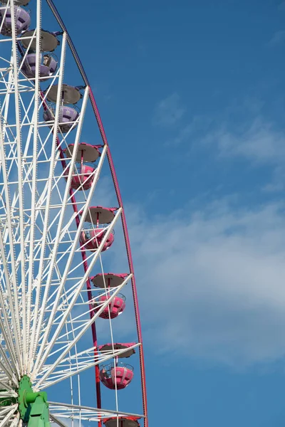 Ferris wheel isolated on blue sky background, Having fun on an amusement fairground park