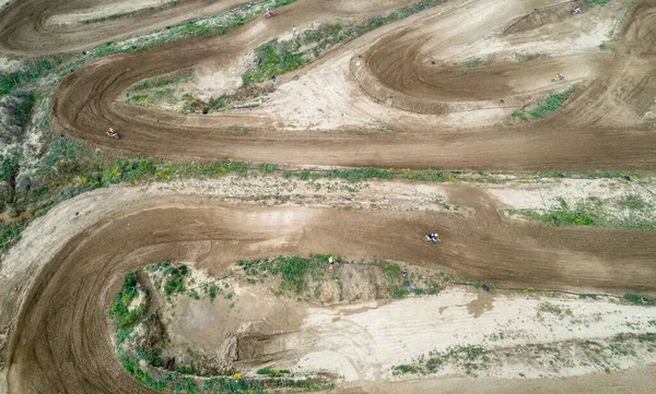 stock image Drone aerial of a motocross race on a dirt curvy sport track. Aerial view of high-speed racing.