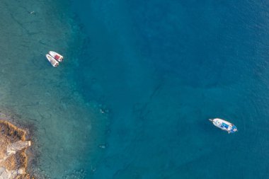 Drone aerial seascape with luxury yacht moored on the coast. Blue water Summer vacations in the sea. Ayia Napa Cyprus