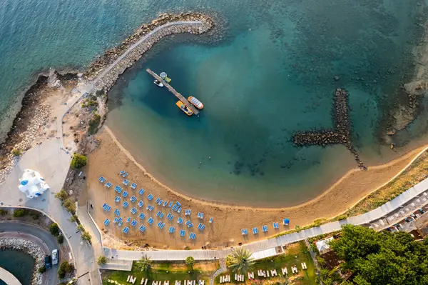 stock image Drone aerial of tropical sandy beach. Beach umbrellas people swimming and relaxing. Summer vacations. Ayia triada, Protaras Cyprus