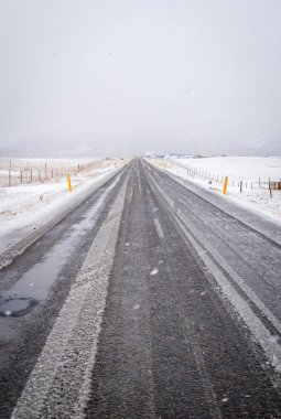 Boş otoyol, İzlanda 'da kışın karla kaplı donmuş yol.