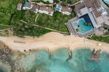 Lüks tatil otellerinin insansız hava aracı antenleri ve kışın kumlu tropik plajlar..