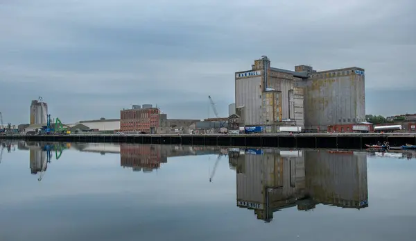 stock image Industrial harbour area infrastructure, Cork city river Lee. Ireland europe. Cloudy day. Building relfection on water