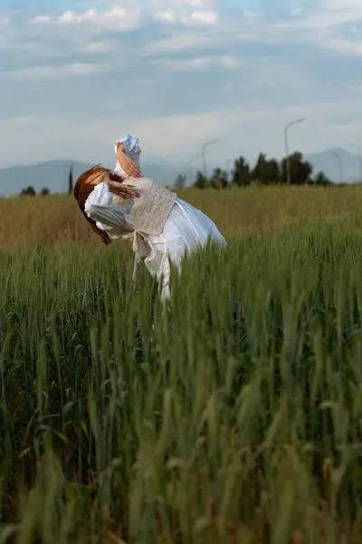 stock image Young dancer woman dancing outdoors. Modern dance performance in the meadow field. Carefree and freedom in nature