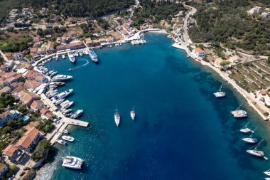 Drone aerial scenery of Greek harbour village of Fiskardo on the Northern tip of Kefalonia Greek island , ionian sea. clipart