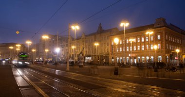 Zagreb, Croatia, October 31 2024: Green tram is moving through ban jelacic square in zagreb, croatia at dusk clipart