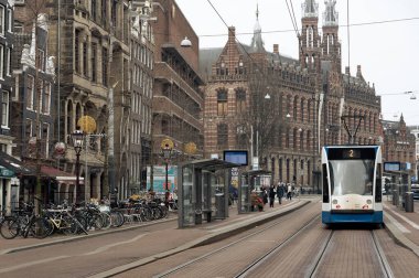Amsterdam Hollanda, 13 Şubat 2025: Amsterdam, Hollanda 'da bir şehir caddesinde tramvaylar ilerliyor, yoğun saat, yoğun saat
