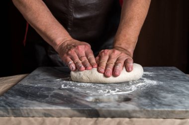 Pizza hazırlayan adam, mermer masada hamur..