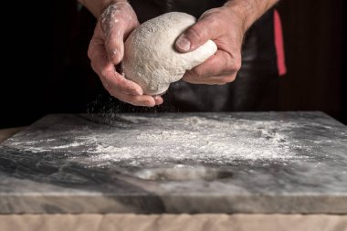 Pizza hazırlayan adam, mermer masada hamur..