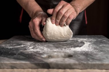 Pizza hazırlayan adam, mermer masada hamur..