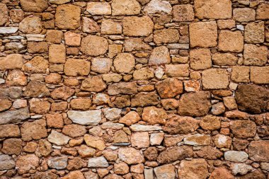 Geçmişi. Taş duvar. Sarı tuğlalar. Sarı taşlar duvar. desen.