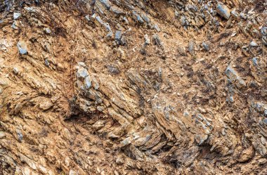 Background. Stones. Pattern. Stone wall from the thickness of limestone layers. Geological cut.