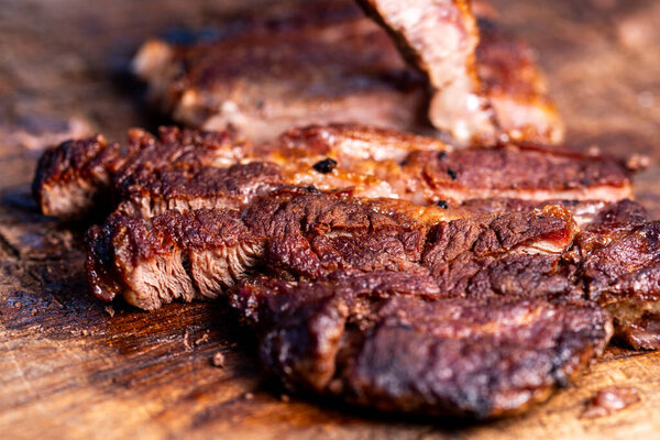 Fresh roast beef meat steak on cutting board. Fresh roast ribeye steak slices.