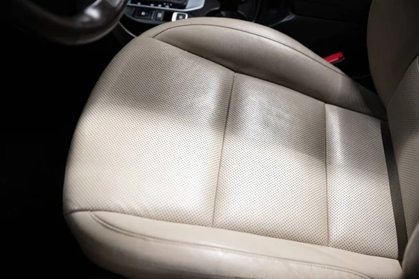 effect before and after cleaning the car upholstery in a car detailing studio or car wash.
