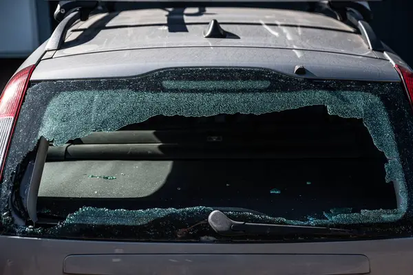 Broken car window after a break-in by a car thief.