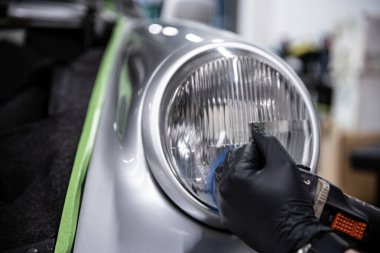 Headlight polishing removes fog and scratches, restoring clarity and enhancing nighttime visibility for a safer drive clipart