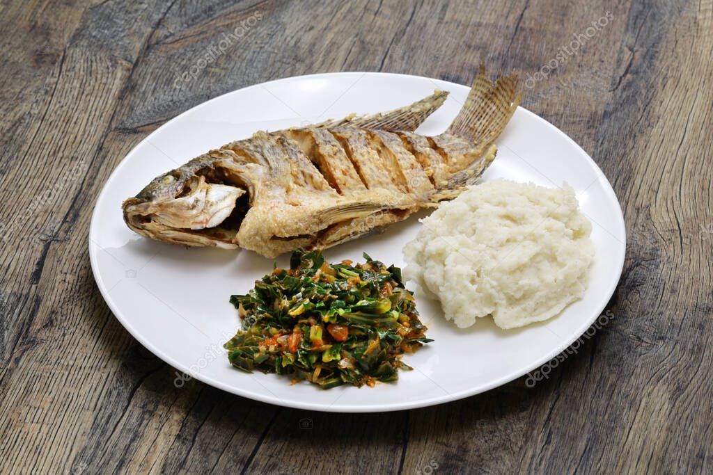 fried fish(Tilapia), ugali(white maize flour mash) and Sukuma Wiki(kale