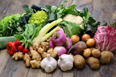 Various vegetables prepared for bagna cauda. Bagna cauda(Italian Piedmont cuisine)is a hot dip made from garlic and anchovies. The dish is served with raw or cooked vegetables used to dip into it. clipart