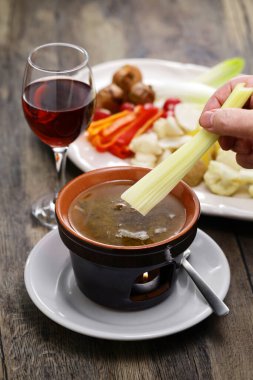 dipping celery. Bagna cauda(Italian Piedmont cuisine)is a hot dip made from garlic and anchovies. The dish is served with raw or cooked vegetables typically used to dip into it.
