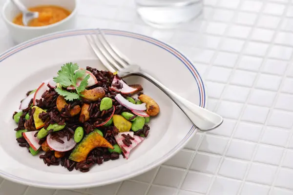 stock image black purple rice (Thai riceberry) salad, vegan cuisine