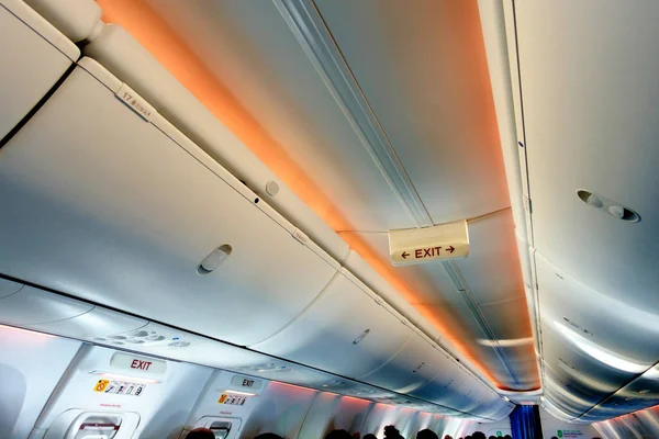 Emergency exit signs in a commercial airplane.Photo without people