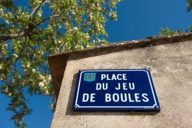 Street sign in French village at a square (in French: place) where people play jeu de boules clipart