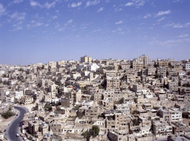 Güneşli bir günde eski Hisar 'dan görüldüğü üzere Amman, Ürdün' ün yoğun ve teraslı binalarına bakın.