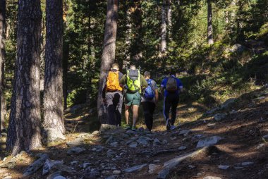 Madrid, Spain - September 30, 2023. A group of hikers walking on Citores peak. Sierra de Guadarrama National park. Madrid, Spain.