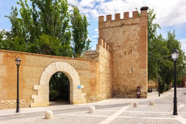 Alcala de Henares, Spain - June 18, 2024. The medieval walls of Alcala de Henares, built in the 13th century, still maintain their original layout, protecting the Archbishops Palace complex. clipart