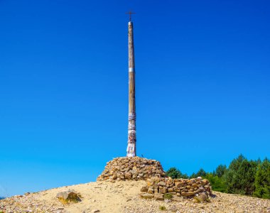 Foncebadon, Spain - August 5, 2024. The iconic Cruz de Ferro, a significant landmark on the Camino de Santiago, near Foncebadon. Castilla y Leon, Spain. clipart