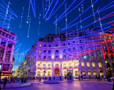 Madrid, İspanya - 4 Aralık 2024. Plaza de Canalejas Meydanı gece karanlığında yılbaşı ışıklarıyla aydınlanırken, arka planda Galerias Canalejas Alışveriş Merkezi yer alıyor. Madrid, İspanya.