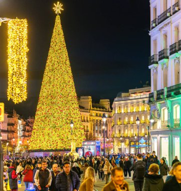 Madrid, İspanya - 4 Aralık 2024. Akşam karanlığında Alcala caddesi yılbaşı ışıklarıyla aydınlatılıyor. Arka planda Puerta del Sol meydanı ve Noel ağacı var..