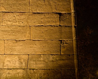 A sunk-relief depiction of two Egyptians leading their dromedaries on the north facade, near west angle, of the Temple of Debod. Madrid, Spain. clipart