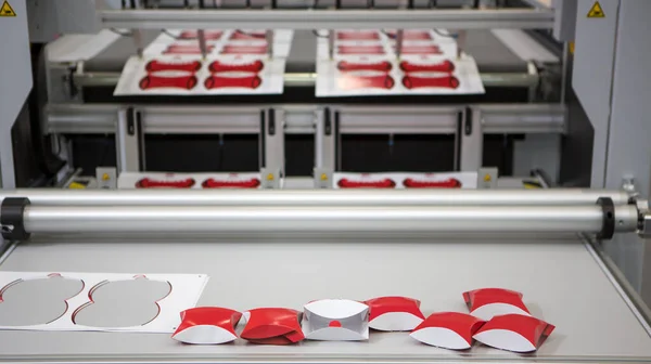 Digital cutting machine. Food folding packaging process on digital cutting machine. Printing industry.