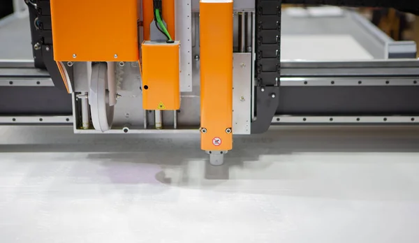 Digital die cut machine cutting plastic sheet. Industrial manufacture.