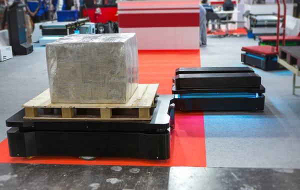 Autonomous Mobile Robot transport carton in modern warehouse. Smart industry.
